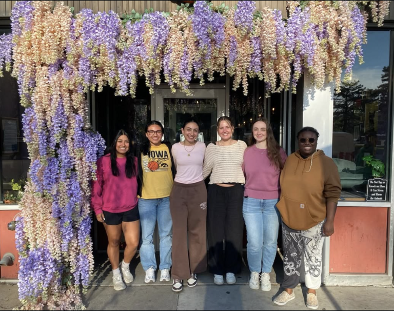 SHRM event members outdoors under a wisteria vine