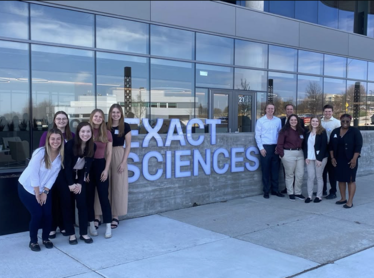 Professional Trip event photo in front of building that says exact sciences